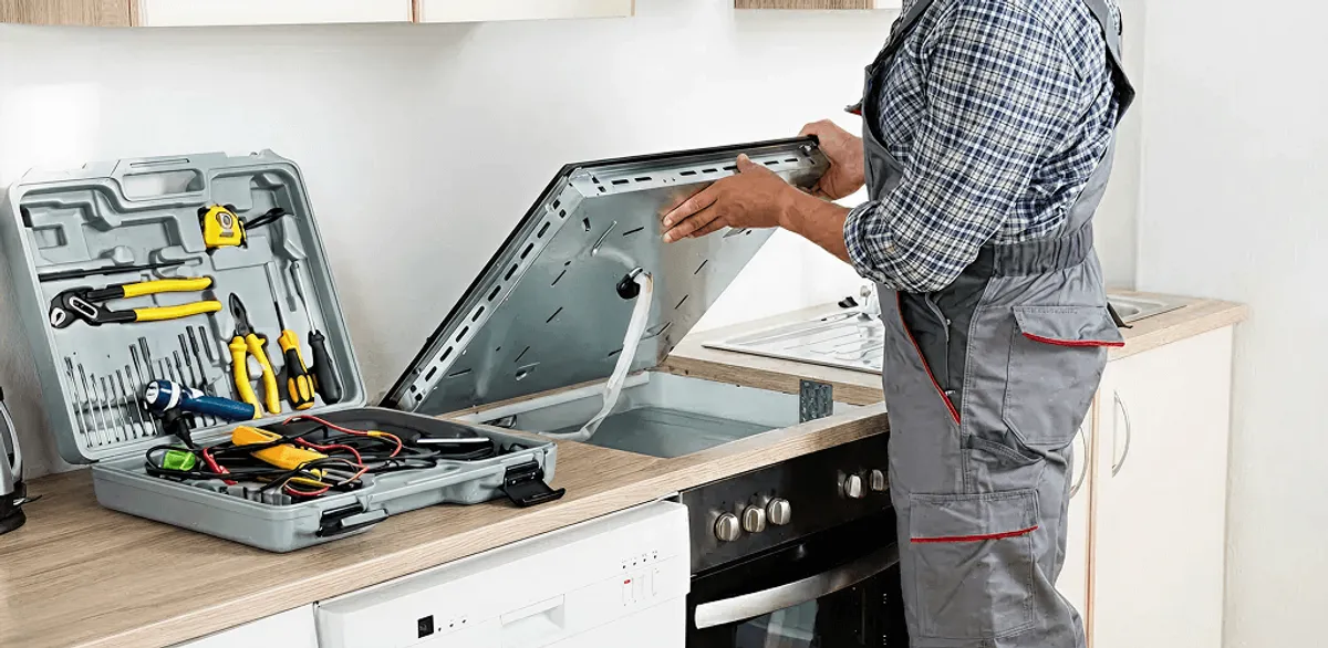 Handyman repairing a cooktop and checking wiring connections in Baltimore, MD