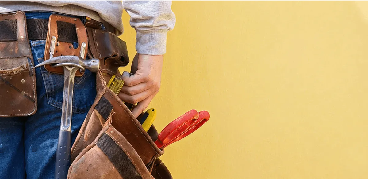 Handyman with tool belt ready for home repairs and maintenance in Baltimore, MD